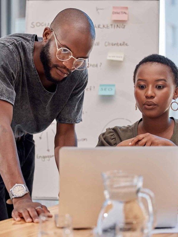 Two corkers looking at a computer.