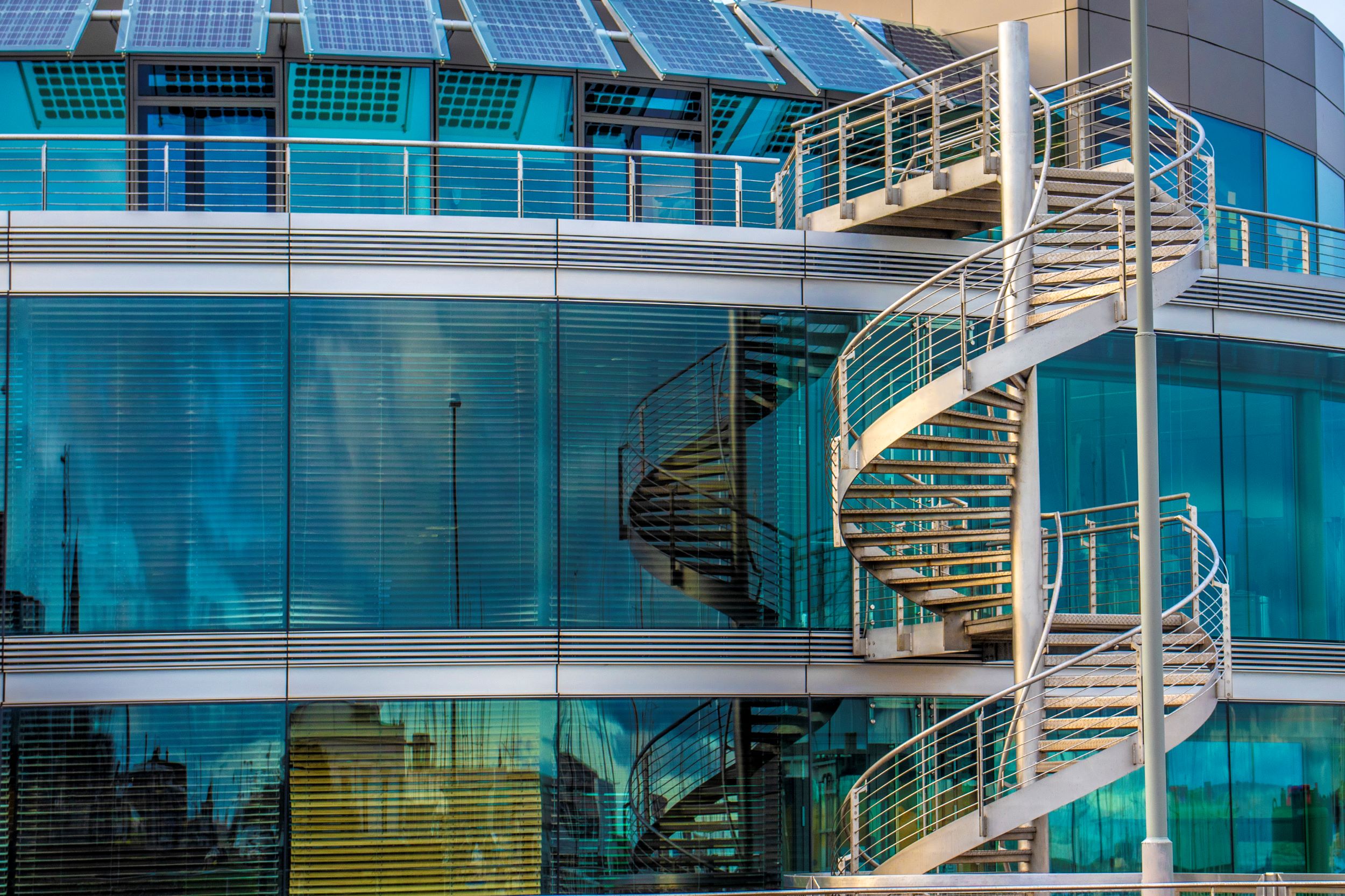 Spiral staircase outside of a modern office building.