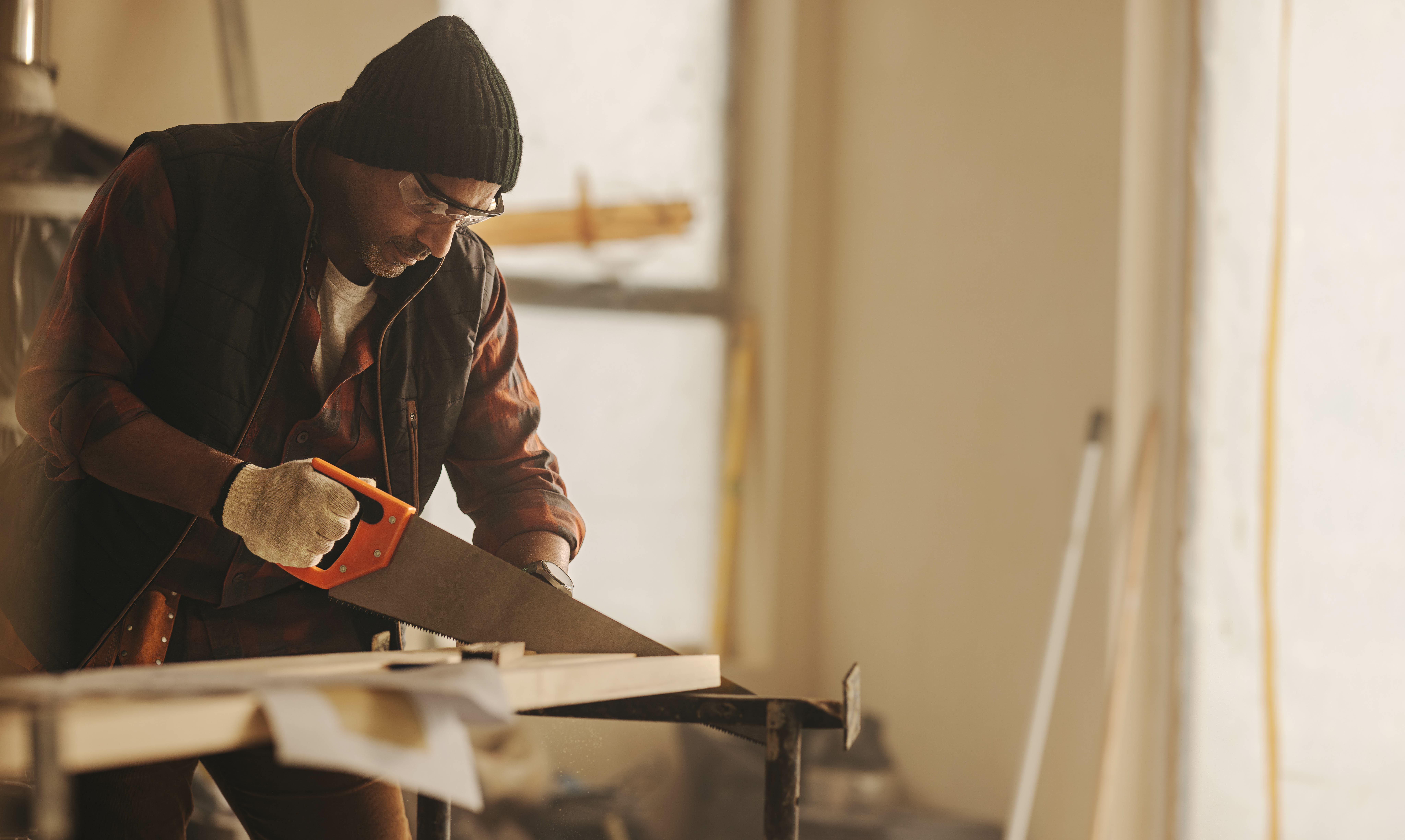 Construction worker sawing